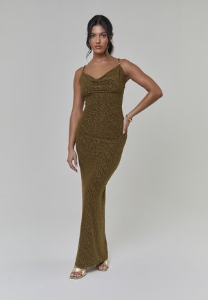 Robe moulante vert olive avec un col bénitier, tissu texturé et fines bretelles ornées d'accents dorés. Design lisse, longueur au sol.