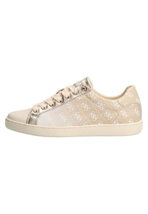Beige low-top sneaker with white monogram pattern, cream laces, metallic gold trim, and off-white rubber sole.