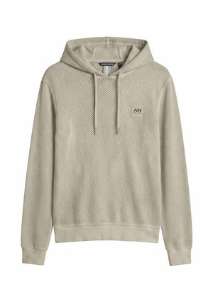 Sudadera con capucha de punto color beige claro, con mangas largas, bolsillo tipo canguro en el frente, capucha con cordón ajustable y pequeño logo cuadrado de la marca en el pecho.