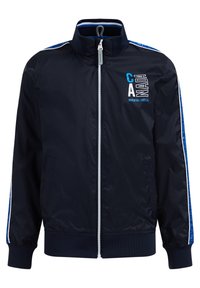 Tummansininen vetoketjupusakka, jossa on valkoinen ja sininen raita hihoissa, ribatut hihansuut ja helmamaalaus sekä "KANADA Waterton Lakes CA" -teksti rinnassa.