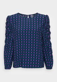 Blusa a quadri viola scuro e verde con maniche a sbuffo, chiusura a occhio di bottone sul retro e un motivo in tessuto strutturato.