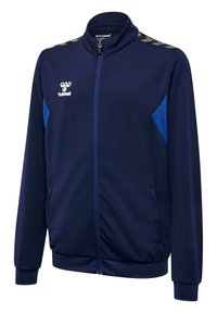 Marinblå sportjacka med hel dragkedja, ståkrage, sidofickor och kontrasterande blå accenter på axlarna. Texturerat tyg.