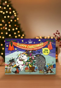 Fluffy Christmas socks calendar featuring cartoon animals against a purple background, with colorful details, numbers, and holiday decorations.