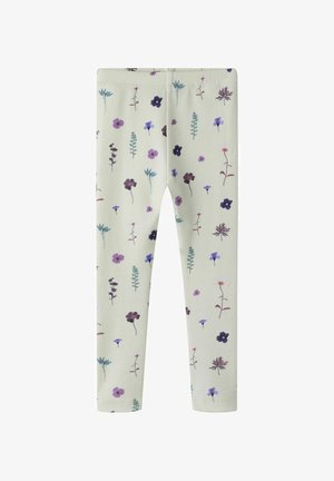 Leggings de color beige claro con un patrón disperso de pequeñas flores silvestres en tonos púrpura, azul y burdeos, acompañadas de tallos verdes con hojas.
