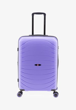 Valise rigide violette avec poignée télescopique étendue et quatre roues pivotantes, positionnée debout sur fond blanc.