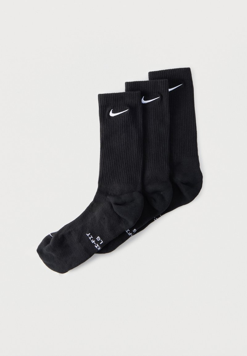Three pairs of black Nike crew socks with white swoosh logos, arranged overlapping on a light background.
