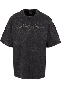Sort oversized t-shirt lavet af tekstureret bomuld, med rund hals og et signaturlogo i skråskrift grå over brystet.