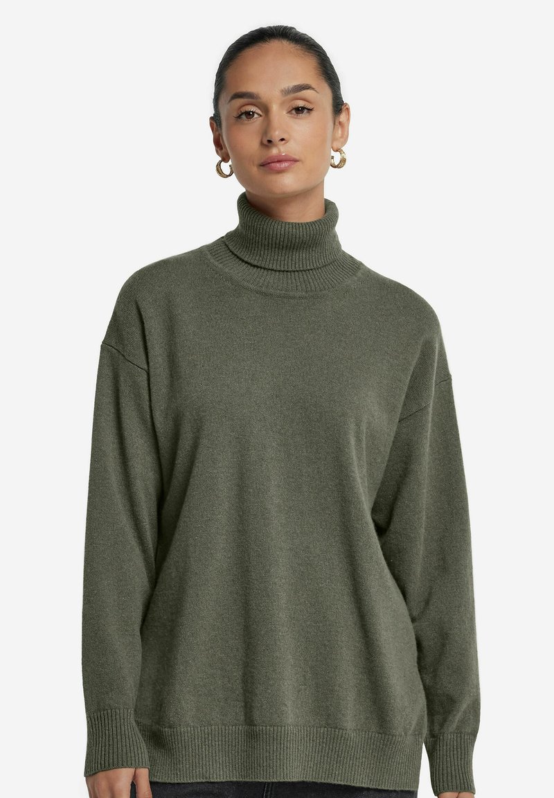 Übergroßer grüner Rollkragenpullover aus weichem Strickstoff, mit gerippten Bündchen und Saum für zusätzlichen Textur und Wärme.