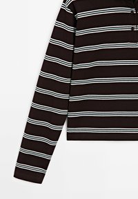 Brown long-sleeve top with horizontal white and light blue stripes, featuring a collar and two buttons. Made from a soft, textured fabric.