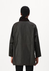Dark green, lightweight jacket with a corduroy collar, drop shoulders, and a relaxed fit, featuring a smooth, slightly crinkled texture.