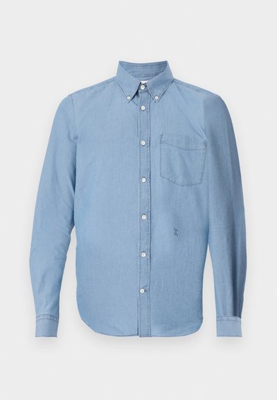 Light blue button-up shirt made of denim fabric. Features a left chest pocket, button-down collar, and long sleeves.