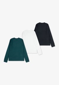 Three long-sleeve t-shirts in dark green, white, and black. Made of soft cotton, featuring crew necks and ribbed cuffs.