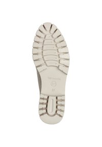 Semelle de sneaker en caoutchouc crème avec un motif de sculpture pour une traction optimale. Présence du logo de la marque et de la taille 37 embossés près du talon.