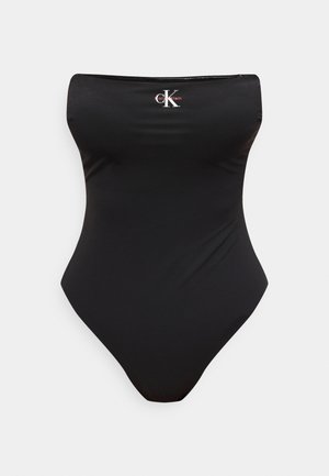 Musta olkaimeton yksiosainen uimapuku, jonka etuosassa yläosassa keskellä on Calvin Kleinin "CK"-logo.