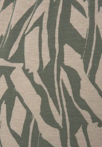 Textile fabric with a green abstract pattern on a beige background, showcasing a soft texture and flowing, organic shapes.