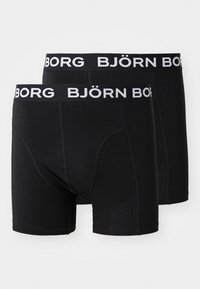 Schwarze Boxershorts aus weichem Stoff, mit einem breiten, elastischen Bund, auf dem "BJÖRN BORG" in Weiß gedruckt ist. Glatte Textur und enganliegendes Design.