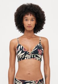 Floral print bralette in black, featuring thin adjustable straps, a V-neckline, and a wrap front design with contrasting leaf patterns.