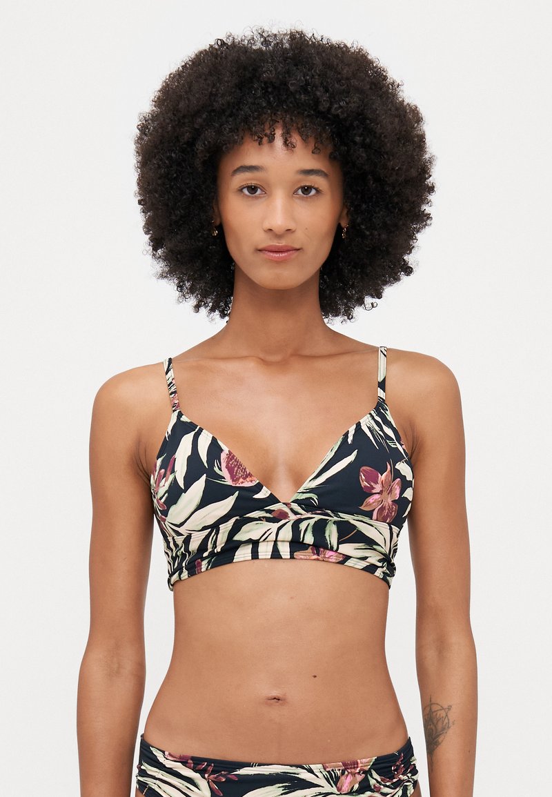 Floral print bralette in black, featuring thin adjustable straps, a V-neckline, and a wrap front design with contrasting leaf patterns.