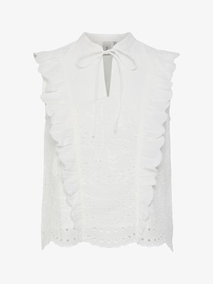 Hvit ermeløs bluse med høy hals, med volanger på kantene og broderte utskjæringsmønstre gjennom hele plagget. Knytning i nakken.