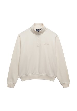 Sweat-shirt crème à fermeture quart de zip, avec poignets et ourlet côtelés, petit logo brodé sur la poitrine gauche et col montant.