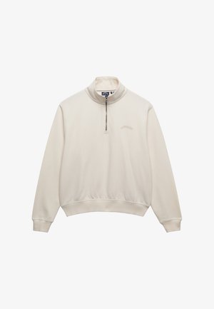 Sweat-shirt crème à fermeture quart de zip, avec poignets et ourlet côtelés, petit logo brodé sur la poitrine gauche et col montant.