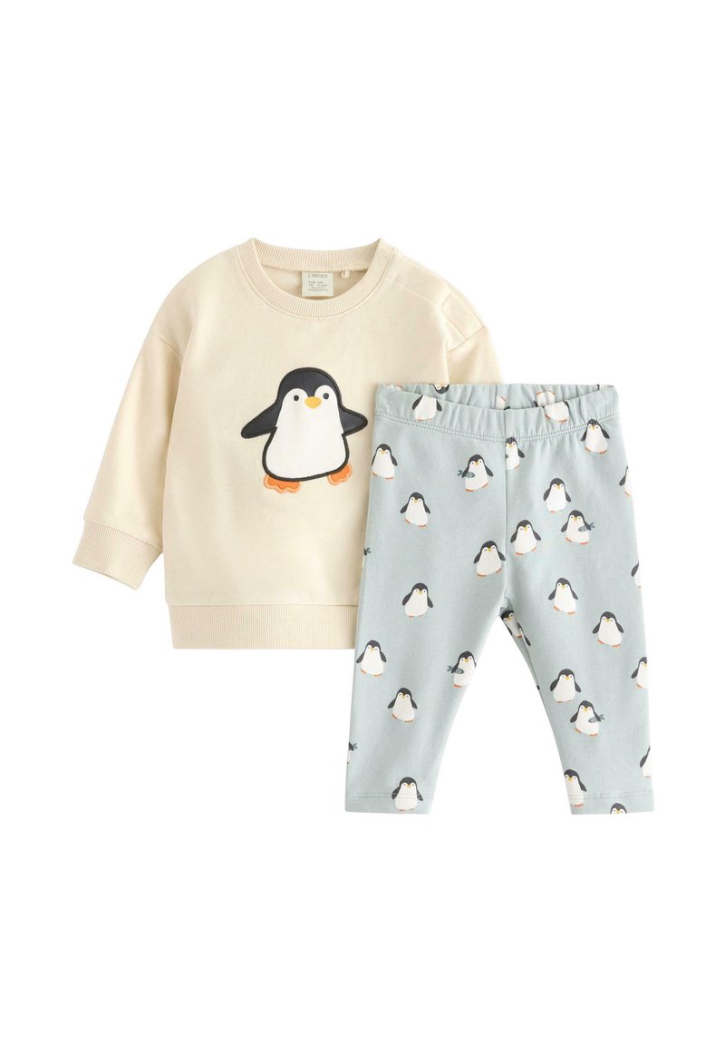 Schlafanzugset mit cremfarbigem Sweatshirt, das ein Pinguin-Motiv zeigt, und hellblauen Hosen mit sich wiederholenden Pinguin-Prints. Aus weichem Stoff gefertigt.