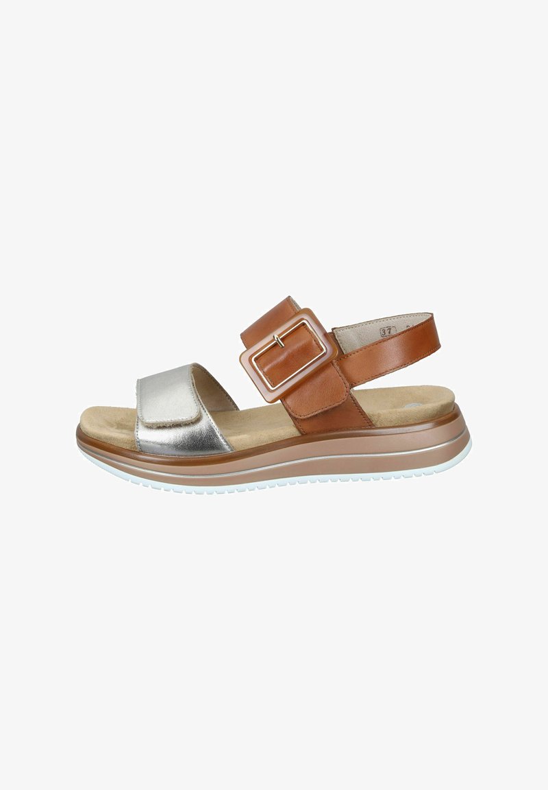 Brown and silver sandal featuring a wide strap with a large buckle, cushioned footbed, and textured rubber sole for grip.