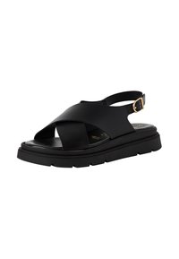 Sandalie negre cu bretele în cruce, design slingback și o talpă groasă, texturată. Prezintă un accent cu cataramă metalică.
