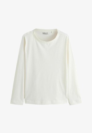 Hosszú ujjú, kerek nyakú póló puha, fehér pamutból. Egyszerű kialakítású, egyenes aljjal és mandzsetta végződésekkel, nincs látható minta vagy díszítés.