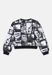 Black and white cropped sweatshirt featuring a collage of images including lips, guitars, and faces, with ribbed cuffs and hem.