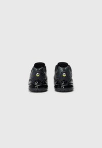 Black athletic sneakers with textured mesh and glossy panels, featuring a high ankle design, rubber sole, and colored logo accents.