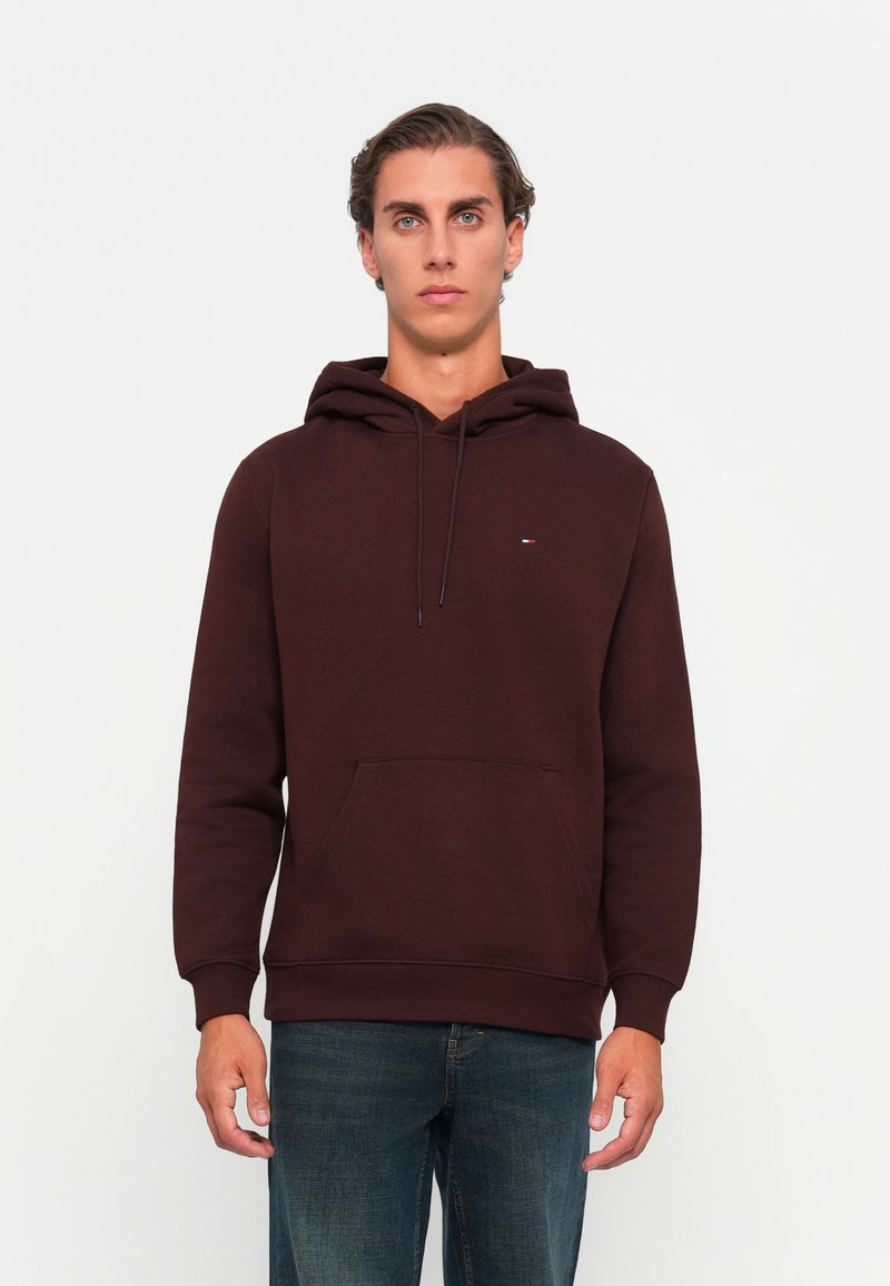 Brown hooded sweatshirt made of cotton blend fabric; features a front pocket, ribbed cuffs, and a small logo on the chest.