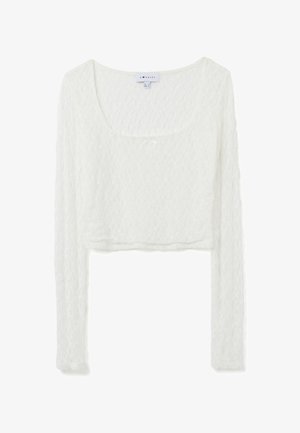 Top corto de manga larga en encaje blanco, con escote redondo y patrón texturizado. Tejido ligero con tacto suave.
