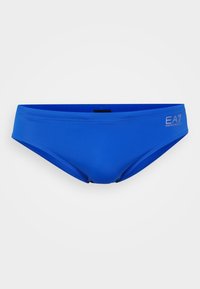 Blå svømmebukser laget av glatt, elastisk stoff. Har en lav midje-design og subtile logodetaljer på siden.
