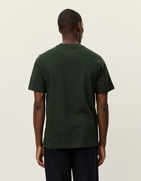 Tmavohnedé bavlnené tričko s krátkymi rukávmi a klasickým okrúhlym výstrihom. Má jednoduchý dizajn a uvoľnený strih. Bez viditeľných log alebo vzorov.