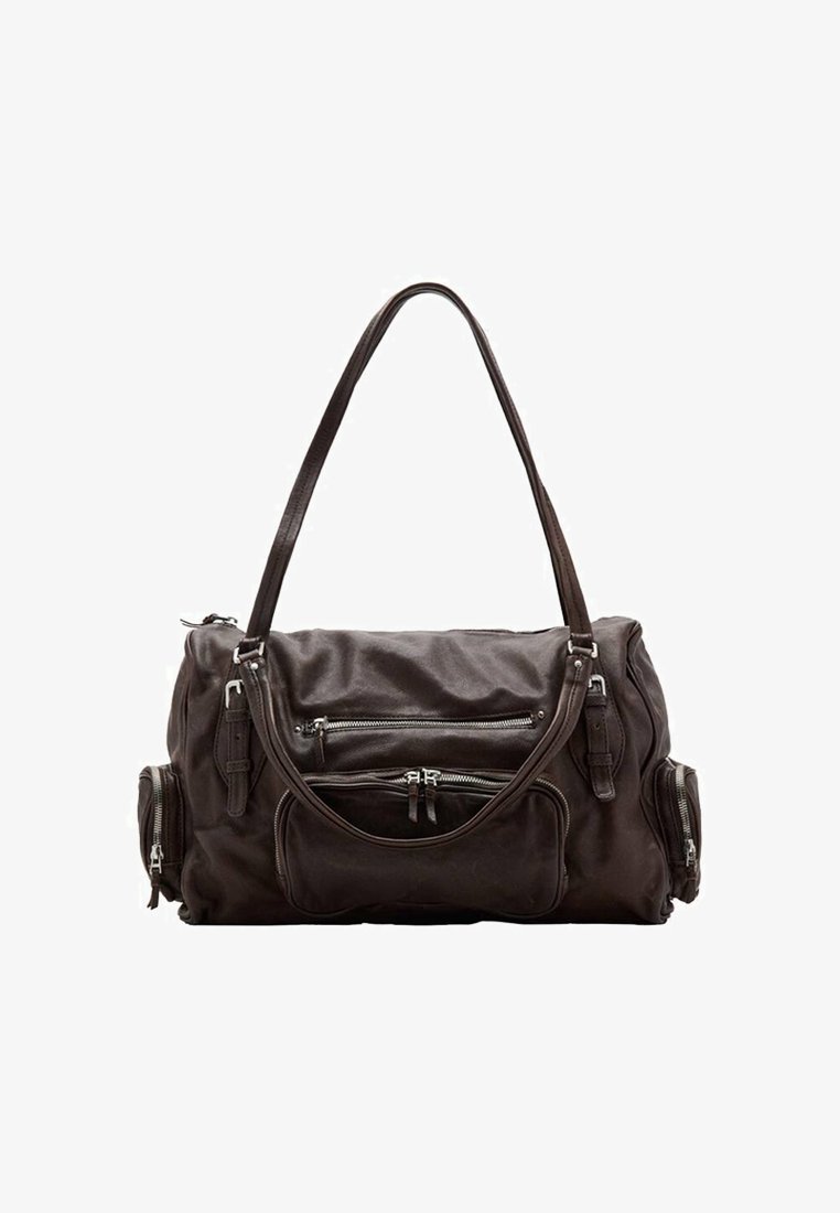 Sac de voyage en cuir marron avec deux poches avant zippées, sangle d'épaule ajustable et forme arrondie. Texture douce, design minimaliste.