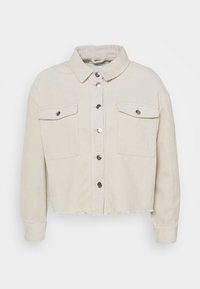 Béžová manšestrová zkrácená bunda s dlouhými rukávy, dvěma předními kapsami s klopami a knoflíky, kovovým zapínáním na patent a roztrhaným lemem.