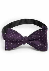 Lila fluga med vita prickar, tillverkad av strukturerad tyg. Justerbar rem med en slät svart innerfoder. Klassisk form.