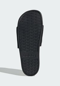 Black Adidas sandal sole with a textured, diamond pattern. Features a flat design and embossed logo on the heel. Classic slip-on style.