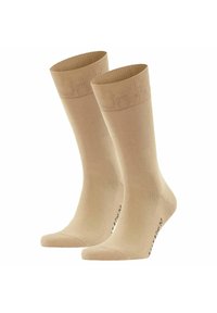 Calcetines beige hasta la rodilla confeccionados con una tela suave. Presentan una parte superior elástica y talones reforzados. Diseño ligero y sin costuras.