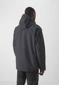Dark gray waterproof jacket with a hood, featuring a textured fabric and loose fit. Minimalist design with no visible hardware or patterns.