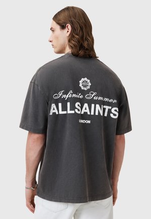 Dark gray oversized t-shirt made of cotton, featuring white printed text "Infinite Summer ALLSAINTS LONDON" on the back, casual fit.