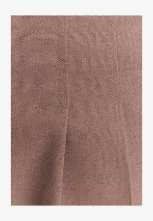 Textured fabric in a soft pink hue, featuring subtle, straight seams and a pleated design without visible patterns or hardware details.