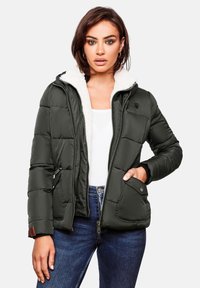 Padded jacket in dark green with a white fleece-lined hood and zippered front. Features two side pockets and ribbed cuffs.
