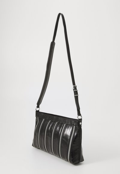 Borsa a spalla in pelle nera con un design strutturato, caratterizzata da dettagli in zip argentati verticali e una tracolla removibile.