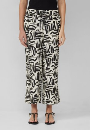 Pantaloni larghi a righe bianchi e neri con un design a foglia, dotati di un elastico in vita e di un tessuto morbido e texture.