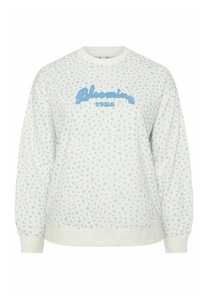 Witte sweatshirt met lange mouwen, een klein lichtblauw bloemmotief en blauwe tekst "Blooming 1986" op de borst.