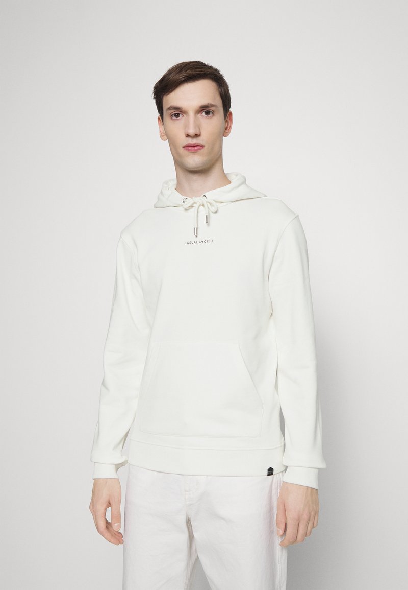 White hooded sweatshirt in soft material, featuring a front pocket, drawstring with silver tips, and a subtle logo in the center.