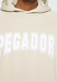 Pegador Jersey con capucha - beige