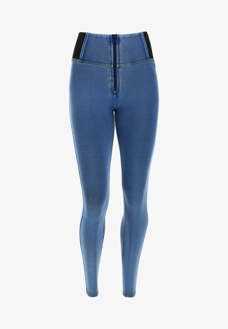 Jean skinny bleu taille haute avec fermeture éclair devant et panneaux latéraux noirs élastiques, présenté sur fond blanc. Aucune personne n'est présente.